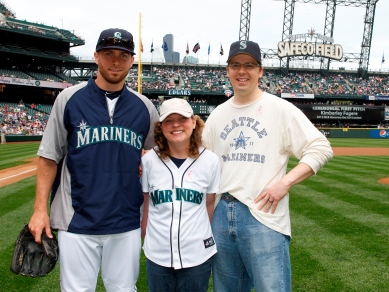 Honorary Bat Girl Kimberly Fugere, her husband Ross, and Dustin Ackley pose for a pregame photo.